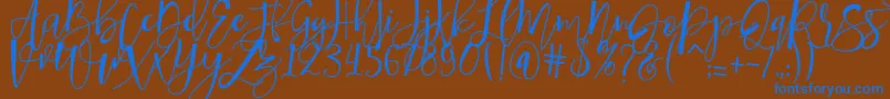 hafizan script-Schriftart – Blaue Schriften auf braunem Hintergrund