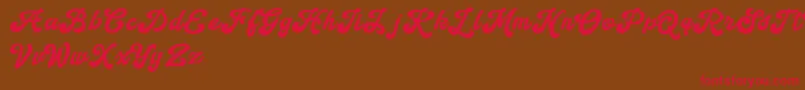 フォントHandy Script – 赤い文字が茶色の背景にあります。