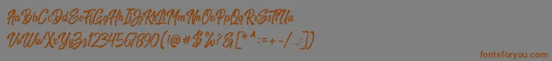 フォントHarpert Script – 茶色の文字が灰色の背景にあります。