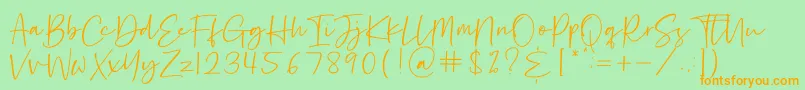 フォントHastage – オレンジの文字が緑の背景にあります。
