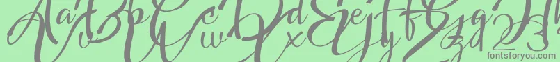 Fonte Headland Script – fontes cinzas em um fundo verde