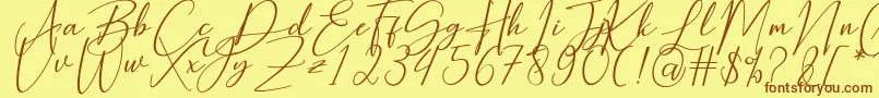 フォントHearth Stone – 茶色の文字が黄色の背景にあります。