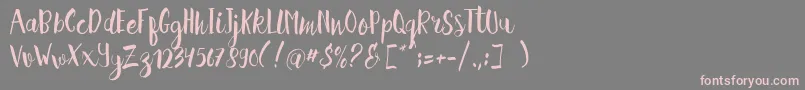 フォントHellena Script Free Sample – 灰色の背景にピンクのフォント