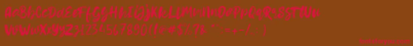 フォントHello Dear Demo – 赤い文字が茶色の背景にあります。