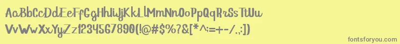 フォントHello Dina Script – 黄色の背景に灰色の文字