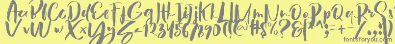 フォントHey Sunset Brush Font – 黄色の背景に灰色の文字