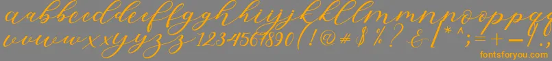 Hiters Script-Schriftart – Orangefarbene Schriften auf grauem Hintergrund