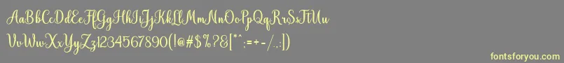 Fonte Hiyida Script Demo – fontes amarelas em um fundo cinza