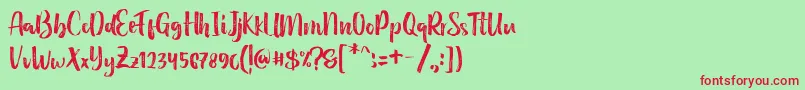 Holidays Handbrush Typeface-Schriftart – Rote Schriften auf grünem Hintergrund
