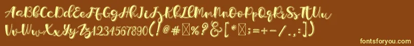 フォントHolligrandina – 黄色のフォント、茶色の背景