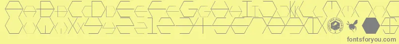 HONEYCOMBED-Schriftart – Graue Schriften auf gelbem Hintergrund