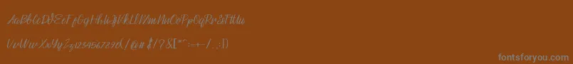 Czcionka Husna – szare czcionki na brązowym tle