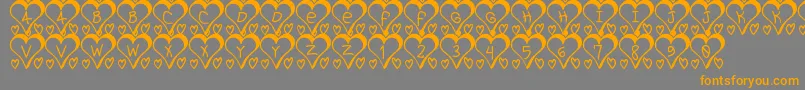 フォントI love St – オレンジの文字は灰色の背景にあります。