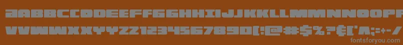 フォントilluminoxtracond – 茶色の背景に灰色の文字