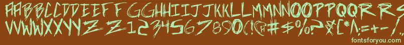 フォントincubus – 緑色の文字が茶色の背景にあります。