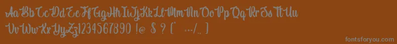 フォントIndigo Daisy – 茶色の背景に灰色の文字