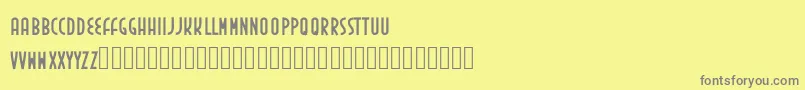 フォントInedita – 黄色の背景に灰色の文字