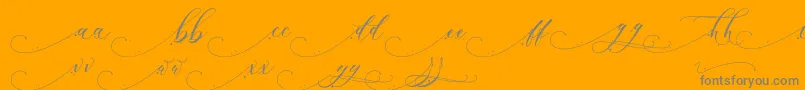 Inkland-Schriftart – Graue Schriften auf orangefarbenem Hintergrund