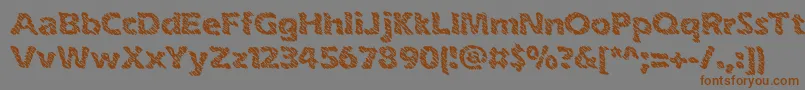 フォントinkswipe – 茶色の文字が灰色の背景にあります。