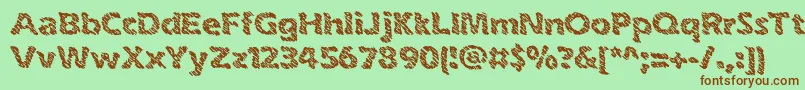 inkswipe-fontti – ruskeat fontit vihreällä taustalla