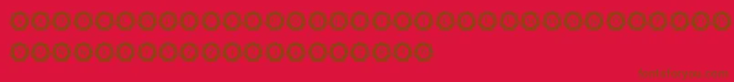 フォントInternationalCapitals – 赤い背景に茶色の文字