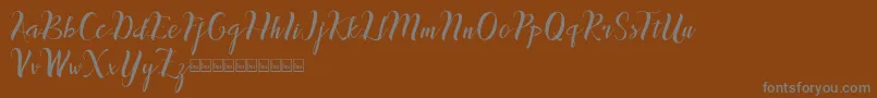 inthai-Schriftart – Graue Schriften auf braunem Hintergrund
