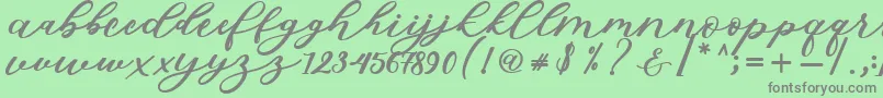 Fonte Isabella Script – fontes cinzas em um fundo verde