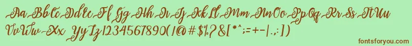 フォントissabeta Script – 緑の背景に茶色のフォント