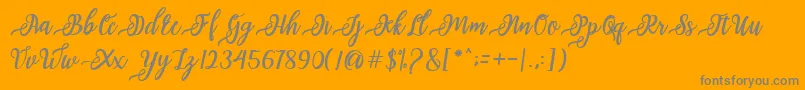 issabeta Script-Schriftart – Graue Schriften auf orangefarbenem Hintergrund