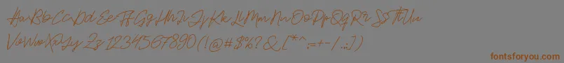 フォントJackson Script – 茶色の文字が灰色の背景にあります。