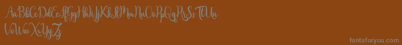 フォントJavinka Script – 茶色の背景に灰色の文字
