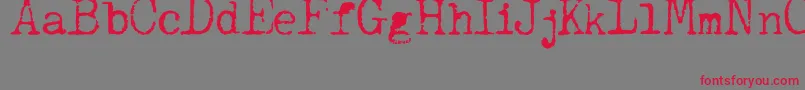 フォントJCAguirrep   Old Type – 赤い文字の灰色の背景