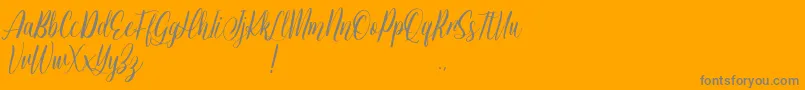 Jessie Odelya Demo-Schriftart – Graue Schriften auf orangefarbenem Hintergrund