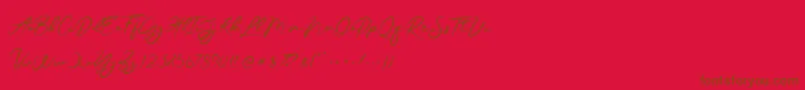 JesterBrush-Schriftart – Braune Schriften auf rotem Hintergrund