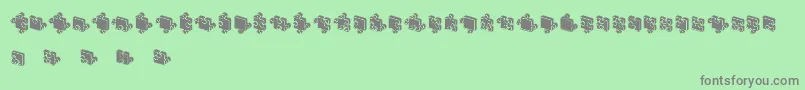 フォントJigsawPuzzles3DFilled – 緑の背景に灰色の文字