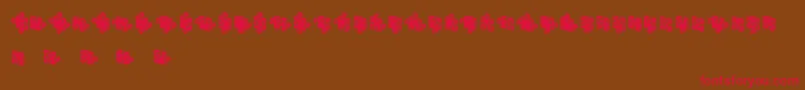 フォントJigsawPuzzles3DFilled – 赤い文字が茶色の背景にあります。