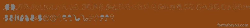 JMH SHERLOCK DINGBATS-fontti – harmaat kirjasimet ruskealla taustalla