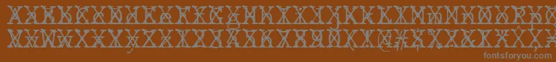 JMH Typewriter mono Fine Cross-fontti – harmaat kirjasimet ruskealla taustalla