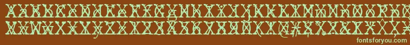 Fonte JMH Typewriter mono Fine Cross – fontes verdes em um fundo marrom