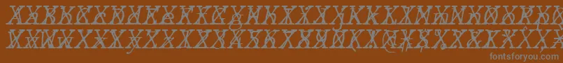 Fonte JMH Typewriter mono Fine Italic Cross – fontes cinzas em um fundo marrom