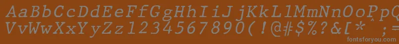 Czcionka JMH Typewriter mono Italic – szare czcionki na brązowym tle