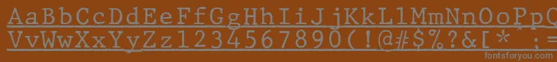 JMH Typewriter mono Under-fontti – harmaat kirjasimet ruskealla taustalla
