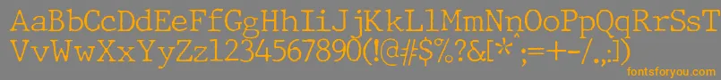 フォントJMH Typewriter Thin – オレンジの文字は灰色の背景にあります。