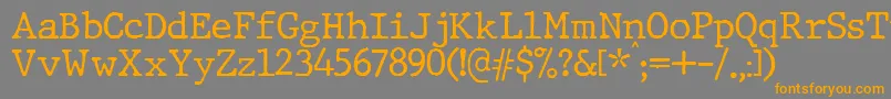 フォントJMH Typewriter – オレンジの文字は灰色の背景にあります。