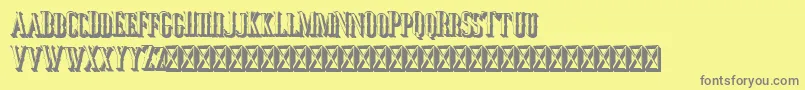 Jocker Extrude Right-fontti – harmaat kirjasimet keltaisella taustalla