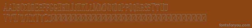 フォントJocker Outline – 茶色の背景に灰色の文字