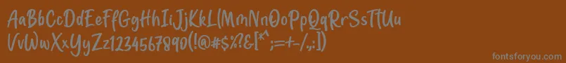 フォントJotilla Font by 7NTypes – 茶色の背景に灰色の文字