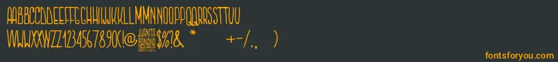 Czcionka Juanita Banana – pomarańczowe czcionki na czarnym tle