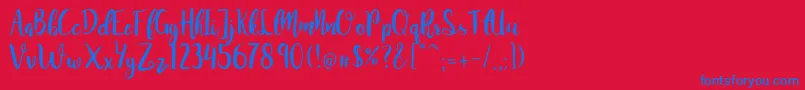 Czcionka JuanitaBrushSmooth – niebieskie czcionki na czerwonym tle