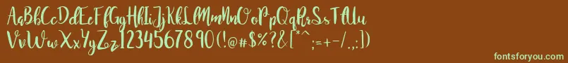 フォントJuanitaBrushSmooth – 緑色の文字が茶色の背景にあります。